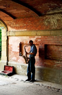 Saxophone player under a bridge in Central Park, New York City, USA, North America