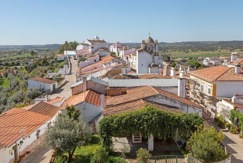 View over rooftops of whitewashed houses and streets in the small rural settlement village of