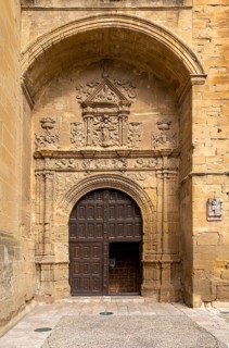 Stonework carvings around wooden doorway to church of Santa Maria de la Asuncion, Briones, La Rioja