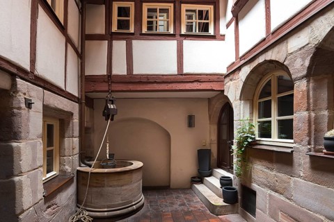 Medieval draw well in an old courtyard in the historic city centre, Nuremberg, Middle Franconia,