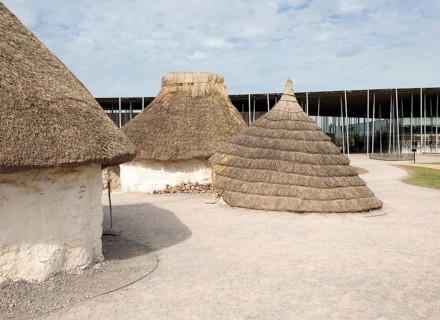 Reconstruction of neolithic homes thatched round houses huts, Stonehenge, Wiltshire, England, UK