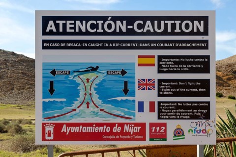 Beach sign caution auto swimmers about danger of rip current, Cabo de Gata natural park, Almeria,