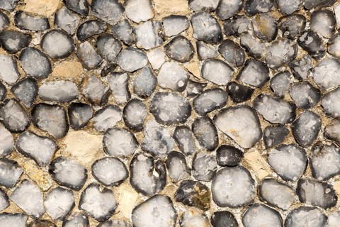 Dressed stone flint wall stonework facing flush work exterior of church of Saint John, Saxmundham,