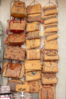 Close up of shop display of handbags made from cork oak souvenir products of butterflies and fish