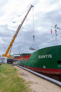 Crane unloading cargo ship Suntis at Anglo-Norden timber merchants, Wet Dock, Ipswich, Suffolk,