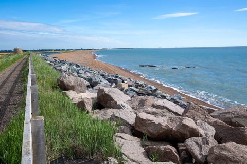 Shingle bay bar and lagoon landforms with rock armour coastal defences at Bawdsey, Suffolk,