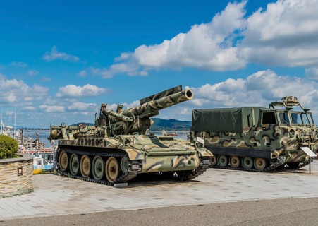 SeosanEight inch self-propelled gun beside M548 tracked cargo carrier on display at seaside park in