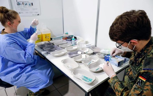 Syringes are filled with the Covid19 Biontech Pfizer vaccine Comirnaty in a vaccination centre by