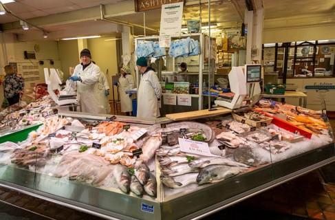 Ashton's fishmonger stall inside the market in city centre of Cardiff, South Wales, UK