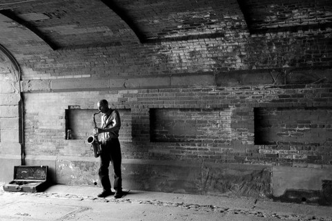Saxophone player under a bridge in Central Park, New York City, USA, North America
