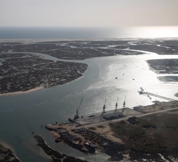 Coastal landscape of salt marsh and drainage channels along the coastline off Faro, Algarve,