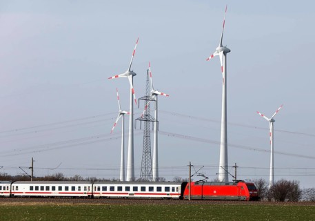A Deutsche Bahn train passes a wind farm, Nauen, 03/03/2021