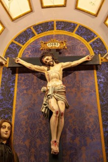 Ornately decorated Jesus Christ crucified on Cross church Igreja de Santiago, Tavira, Algarve,