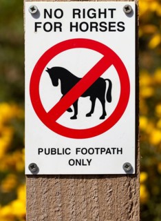 Macro close up No Right For Horses Public Footpath Only sign on fencepost, Sutton, Suffolk,