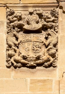 Family coat of arms carved in stone on corner of historic building, crest of Don Pedro Mendoza