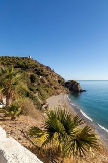 Sandy beach of Playa de Maro, near Nerja, Andalusia, Spain with calm Mediterranean Sea, out of