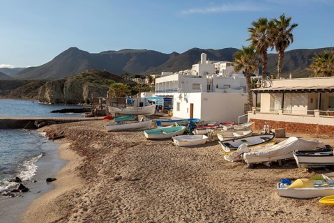Small boats dinghies on sandy beach at Isleta del Moro, Cabo de Gata natural park, Almeria, Spain,