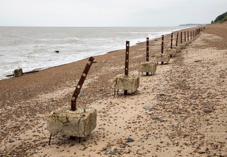 Remains of steel stanchions for barbed wire anti-invasion defences on beach at Bawdsey, Suffolk,