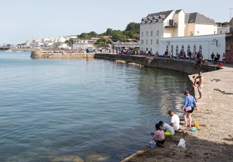 People crabbing from quayside, Swanage, Dorset, England, UK
