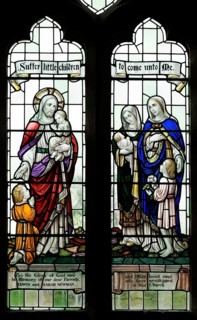 Stained glass windows in All Saints church, Lydiard Millicent, Wiltshire, England, UK