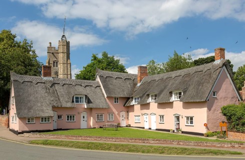Attractive pink thatched cottages and church village of Cavendish, Suffolk, England, UK, Hyde Park