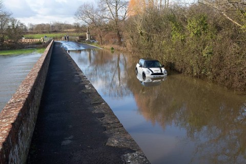 Mini Cooper S car stuck in River Avon flood water, Kellaways bridge, Wiltshire, England, UK
