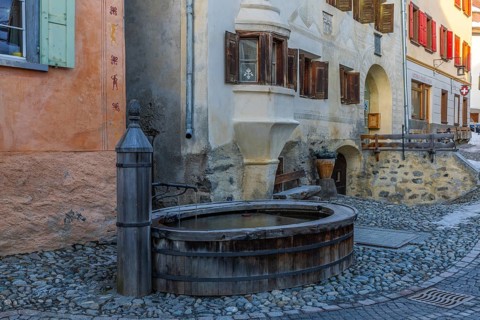 Wooden fountain, house with sgraffito, facade decorations, historic houses, Guarda, Engadin,