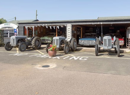 Old cars and Massey Ferguson tractors on display at Stonham Barns, Suffolk, England, UK