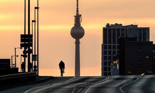 A cyclist alone on the otherwise busy Frankfurter Allee, Berlin, 29/03/2021