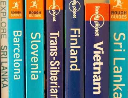 Close up of various travel guide books published by Lonely Planet and Rough Guides