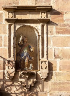 Historic buildings in town of Ezcaray, La Rioja Alta, Spain statue in niche of building