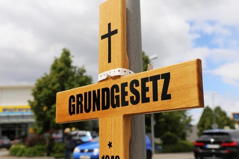Symbolic grave cross with inscription on the Basic Law at a protest organised by critics of the