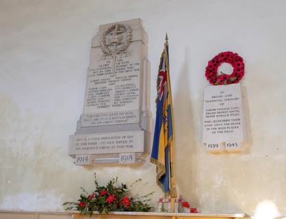 War memorial flag and poppy wreath inside the church at Tunstall, Suffolk, England, UK