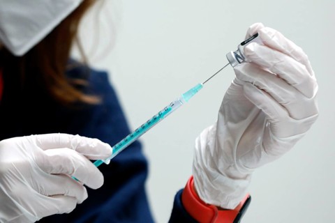 Drawing up a syringe with the Biontech Pfizer active ingredient Comirnaty against Covid19 in a
