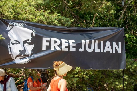 Flag with the inscription Free Julian (Assange) at a peace demonstration in Ramstein