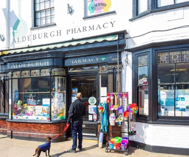 Aldeburgh pharmacy shop, Aldeburgh, Suffolk, England, UK traditional shop frontage and window