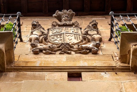 Family coat of arms carved in stone on corner of historic building, San Asensio, La Rioja Alta,