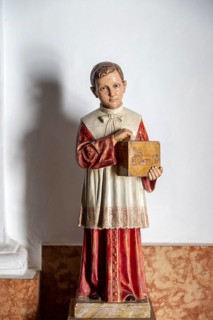Model of young boy holding offertory collecting box at exit of church, Frigiliana, Malaga province,