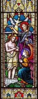 Stained glass window in church of Saint John the Baptist, Badingham, Suffolk, England, UK circa