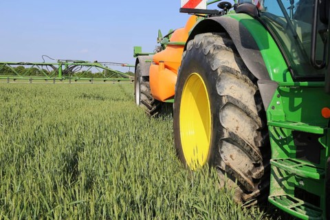 A farmer from the Schmitt vegetable farm in Hockenheim drives his tractor with a crop protection
