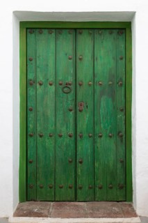 Faded green paint traditional wooden house door, Frigiliana, Axarquia, Andalusia, Spain, Europe