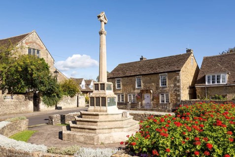 Historic Cotswold stone buildings and war memorial in Canon Square, Melksham, Wiltshire, England,