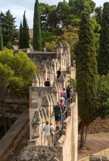 People exploring the defensive ramparts Castillo de Gibralfaro castle walls, Malaga, Andalusia,
