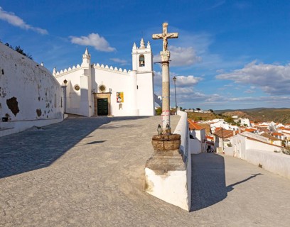 Historic whitewashed church Igreja Matrix in medieval village of Mertola, Baixo Alentejo, Portugal,