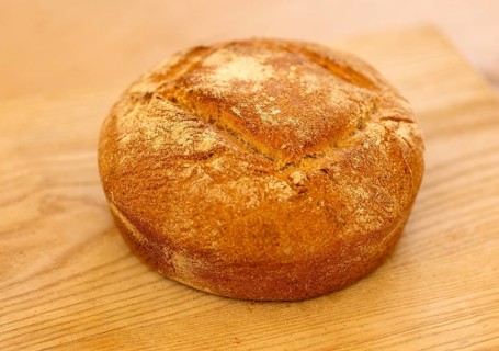 Close up of freshly baked loaf of bread on kitchen table