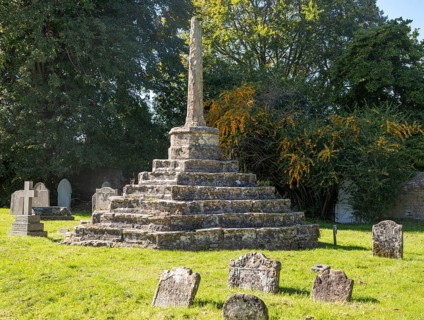 Medieval churchyard standing cross and ancient gravestones, Chew Magna, Somerset, England, UK