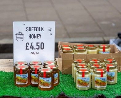 Display of jars of Suffolk honey on sale at street market, England, UK