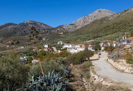 Small village of Aldea de Guaro, Periana, Axarquia, Andalusia, Spain at base of limestone mountains