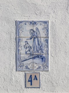 Azulejo tile ceramic image of guardian angel above house door, village of Alvito, Baixo Alentejo,