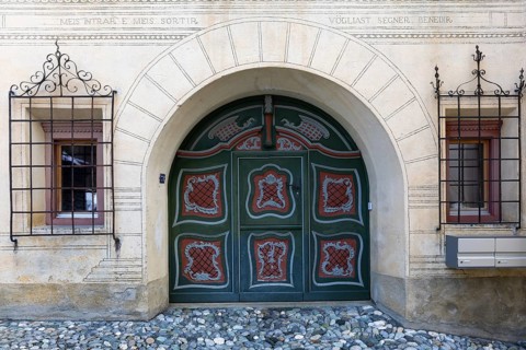 Large painted wooden door, window, historic house, sgraffito, facade decorations, Ardez, Engadin,